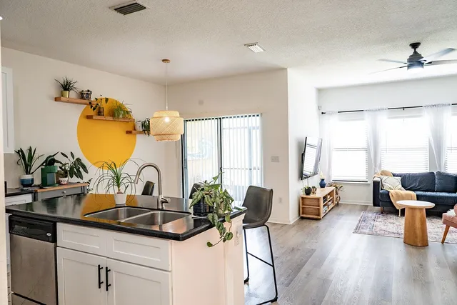a bathroom with a granite countertop sink and large mirror