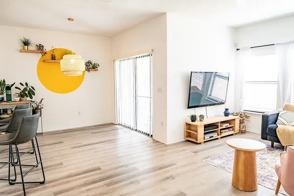 a living room with furniture and a mirror