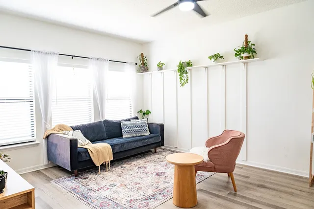 a living room with furniture and wooden floor