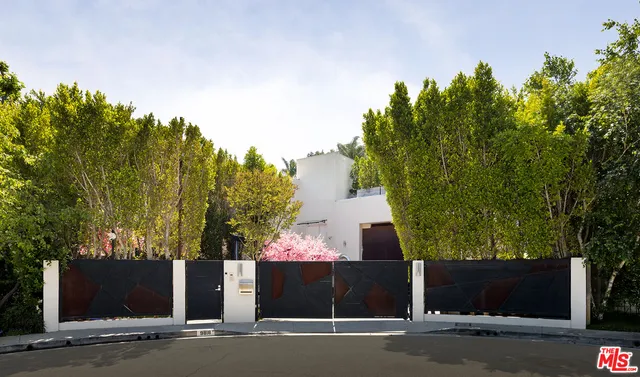 a front view of a house with trees