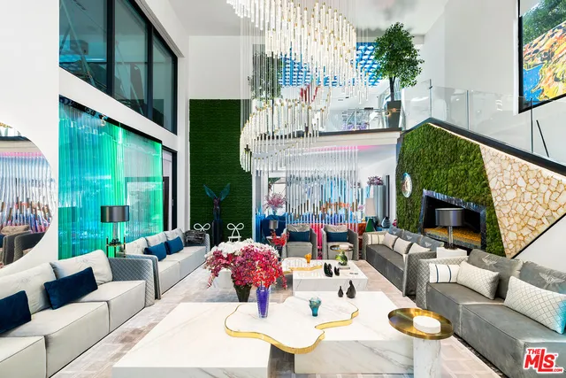 a view of a patio with couches table and chairs with potted plants