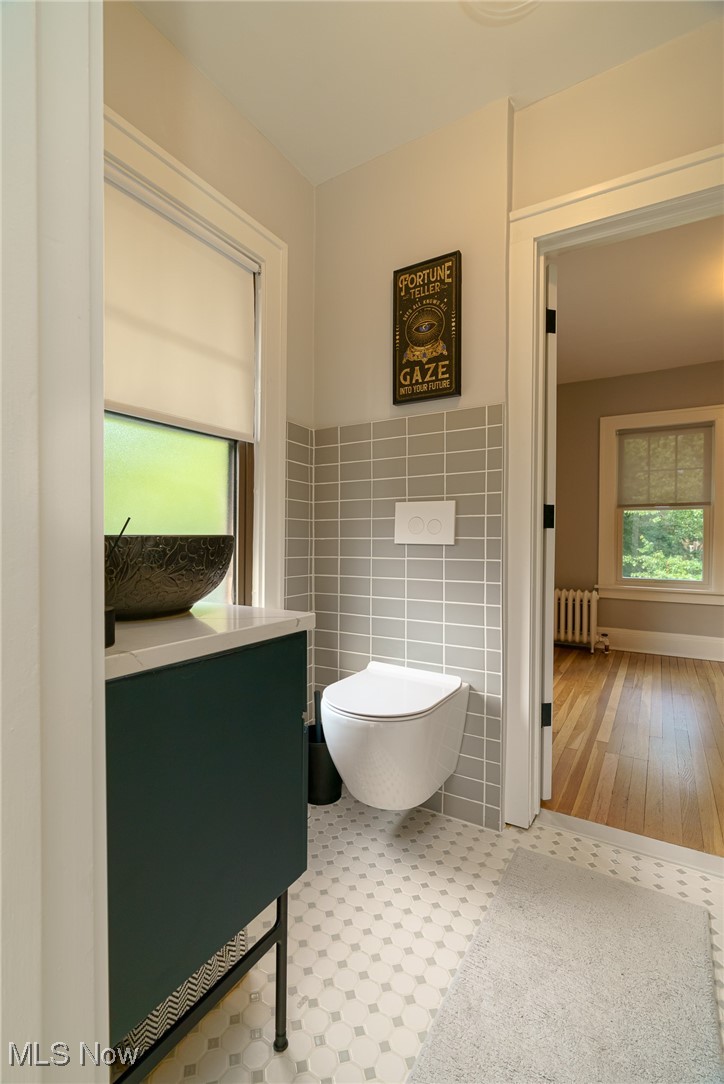2624 Lee Road Cleveland, OH 44118 - Photo 24 of 50 Bathroom with tile walls, and easy to clean under wall mounted toilet!