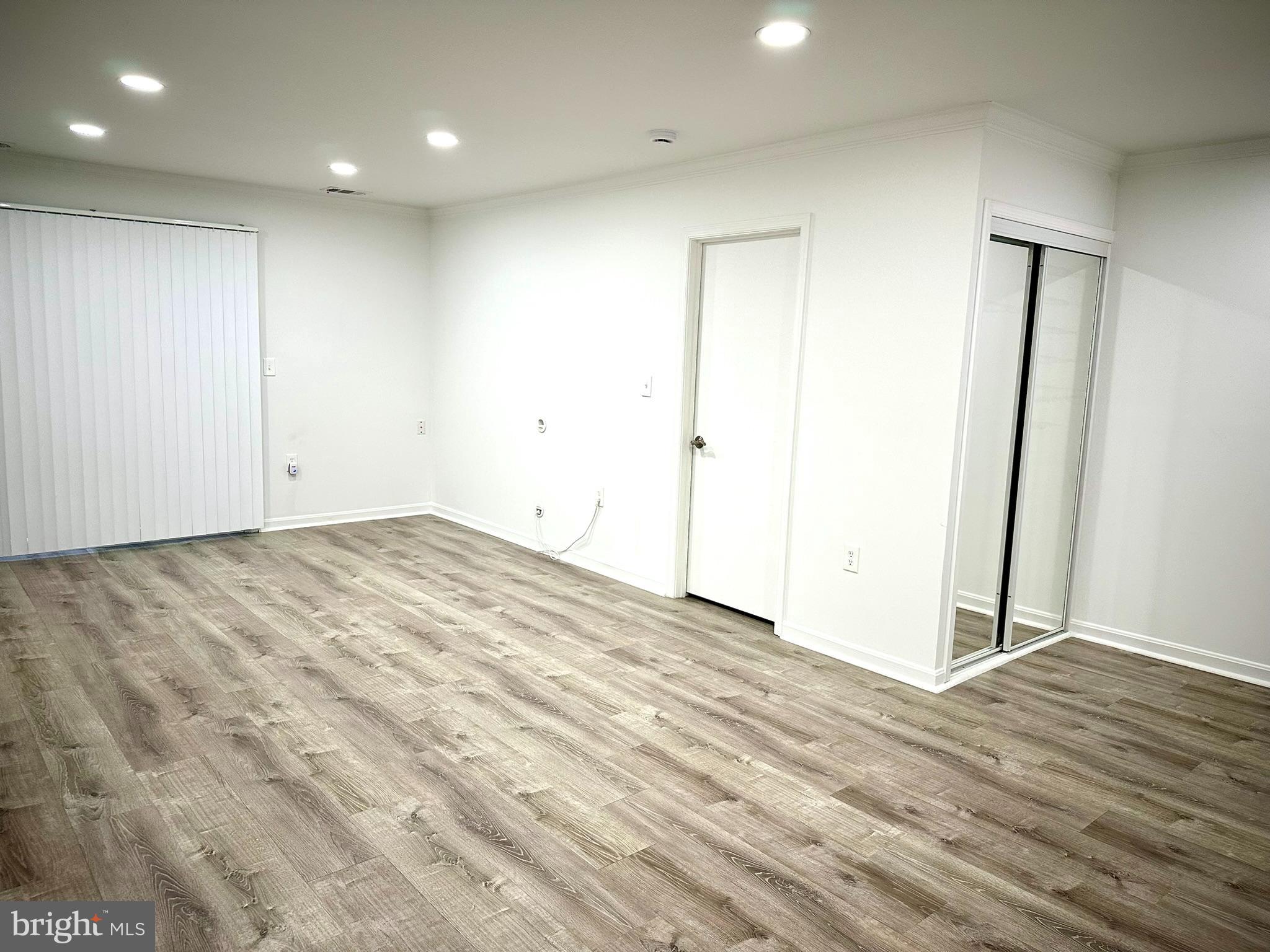 18334 Streamside Drive, Unit 202 Gaithersburg, MD 20879 - Photo 14 of 61 an empty room with wooden floor and entrance