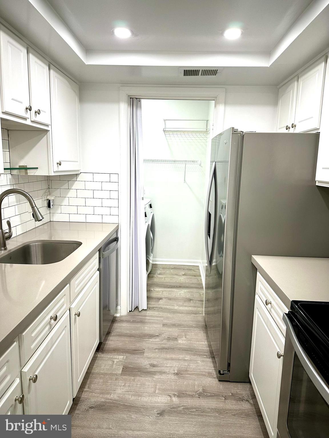 18334 Streamside Drive, Unit 202 Gaithersburg, MD 20879 - Photo 15 of 61 a kitchen with a refrigerator sink and stove