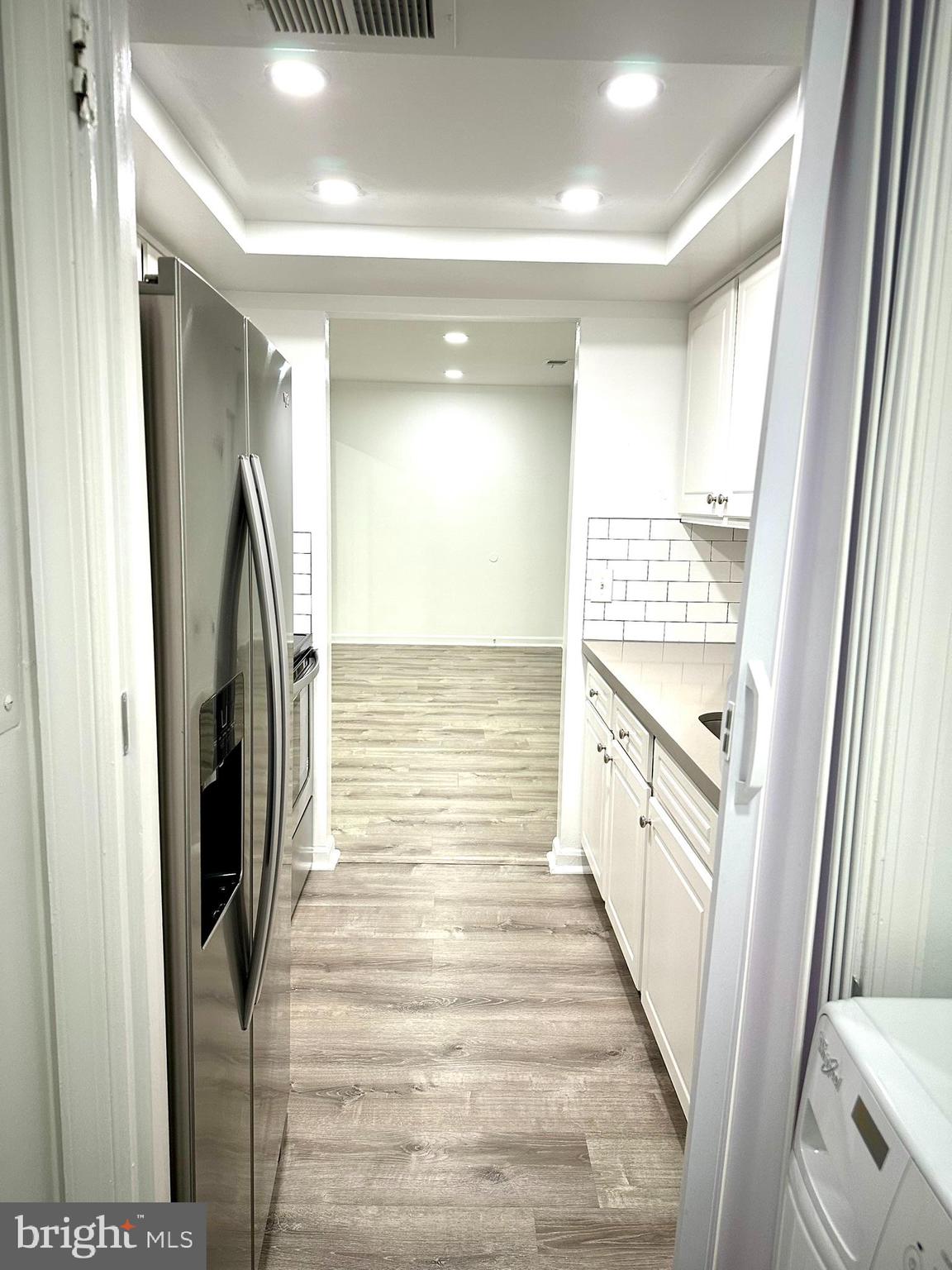 18334 Streamside Drive, Unit 202 Gaithersburg, MD 20879 - Photo 19 of 61 a view of a hallway with wooden floor and staircase