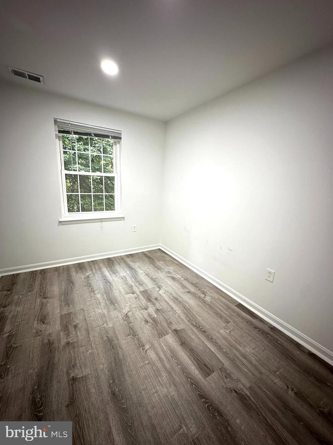 18334 Streamside Drive, Unit 202 Gaithersburg, MD 20879 - Photo 24 of 61 an empty room with wooden floor and windows