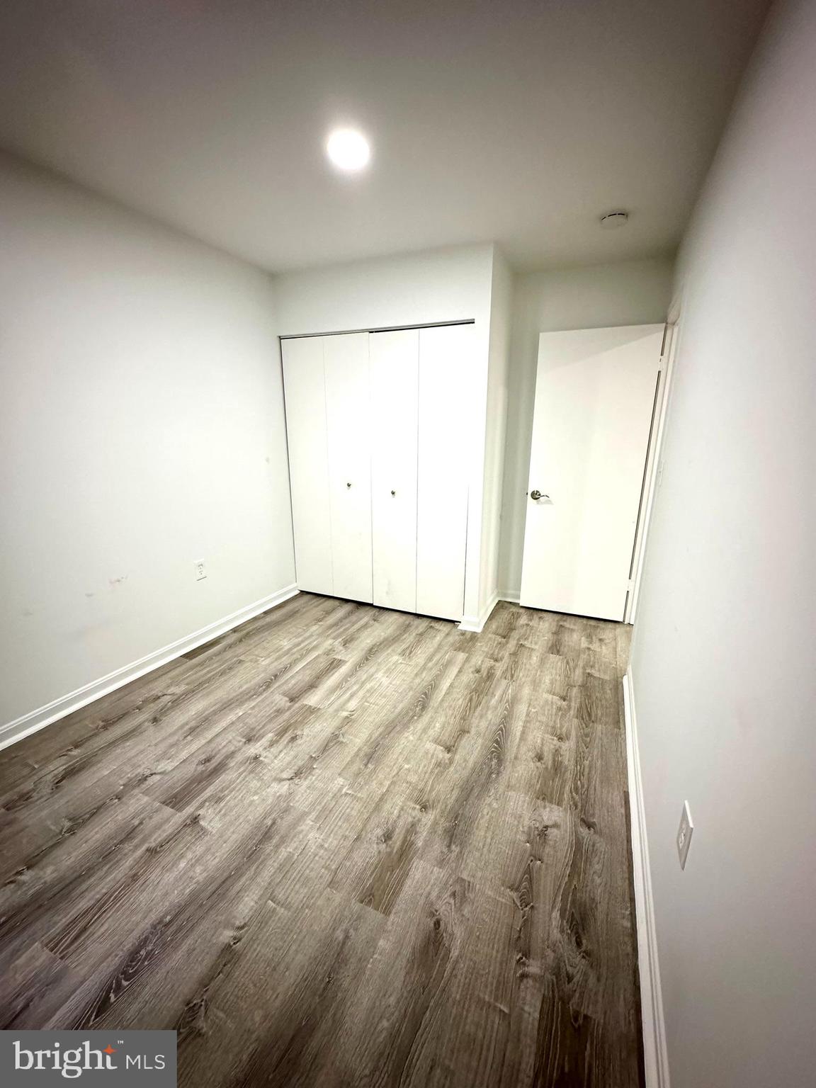 18334 Streamside Drive, Unit 202 Gaithersburg, MD 20879 - Photo 25 of 61 an empty room with wooden floor