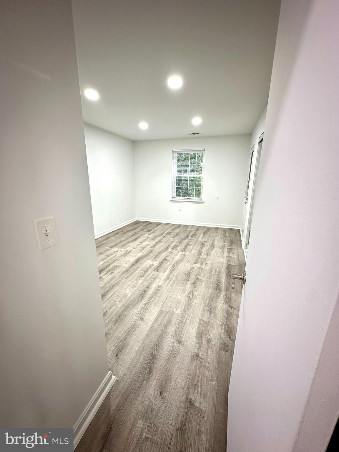 18334 Streamside Drive, Unit 202 Gaithersburg, MD 20879 - Photo 26 of 61 wooden floor in an empty room with a window