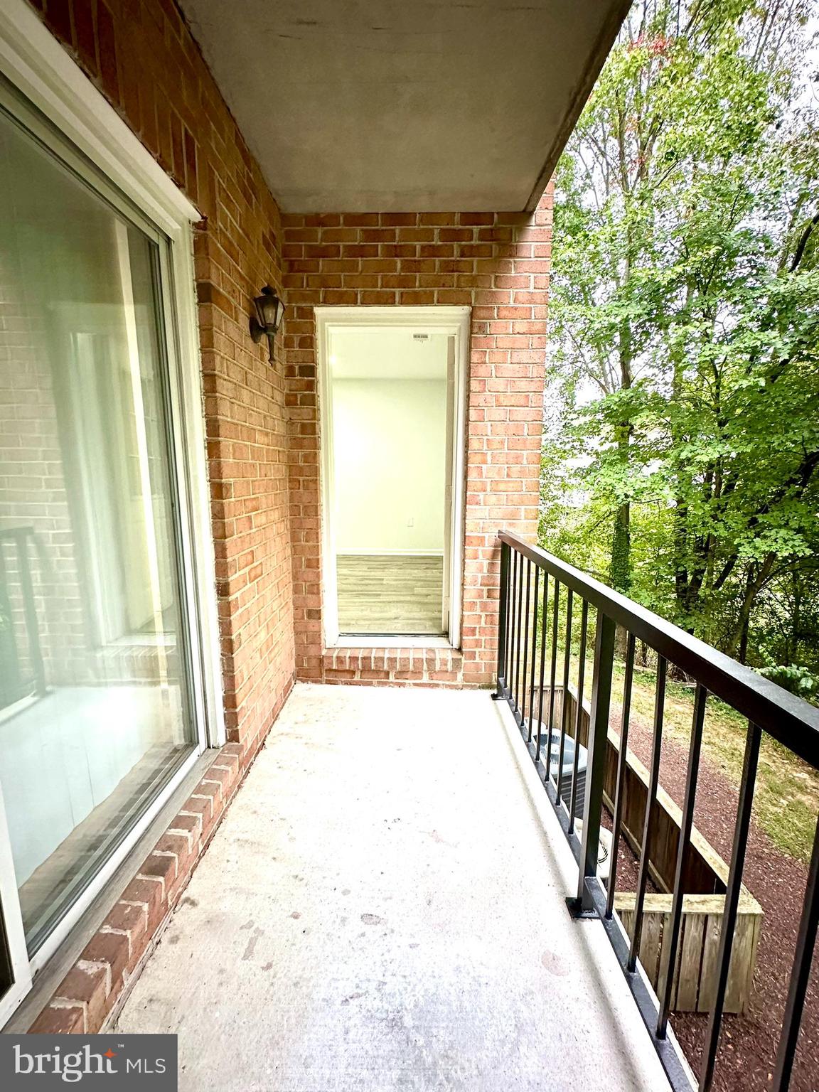 18334 Streamside Drive, Unit 202 Gaithersburg, MD 20879 - Photo 31 of 61 a view of a porch with wooden floor and door