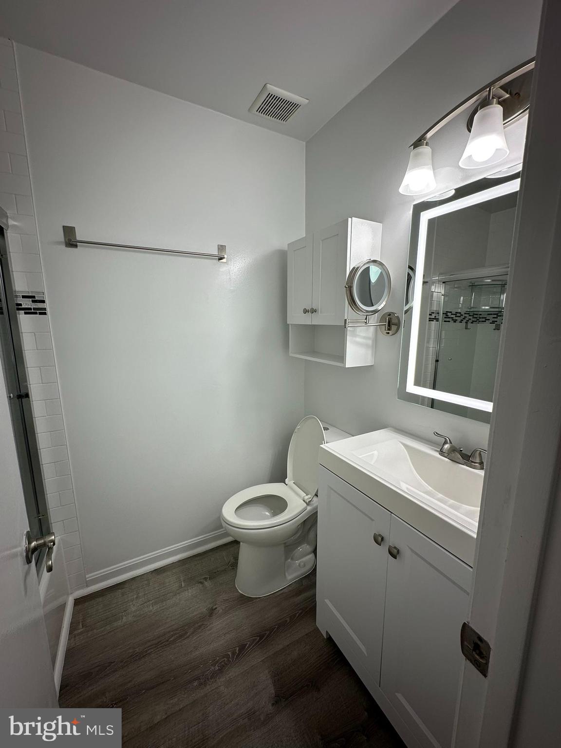 18334 Streamside Drive, Unit 202 Gaithersburg, MD 20879 - Photo 35 of 61 a bathroom with a toilet a sink and mirror