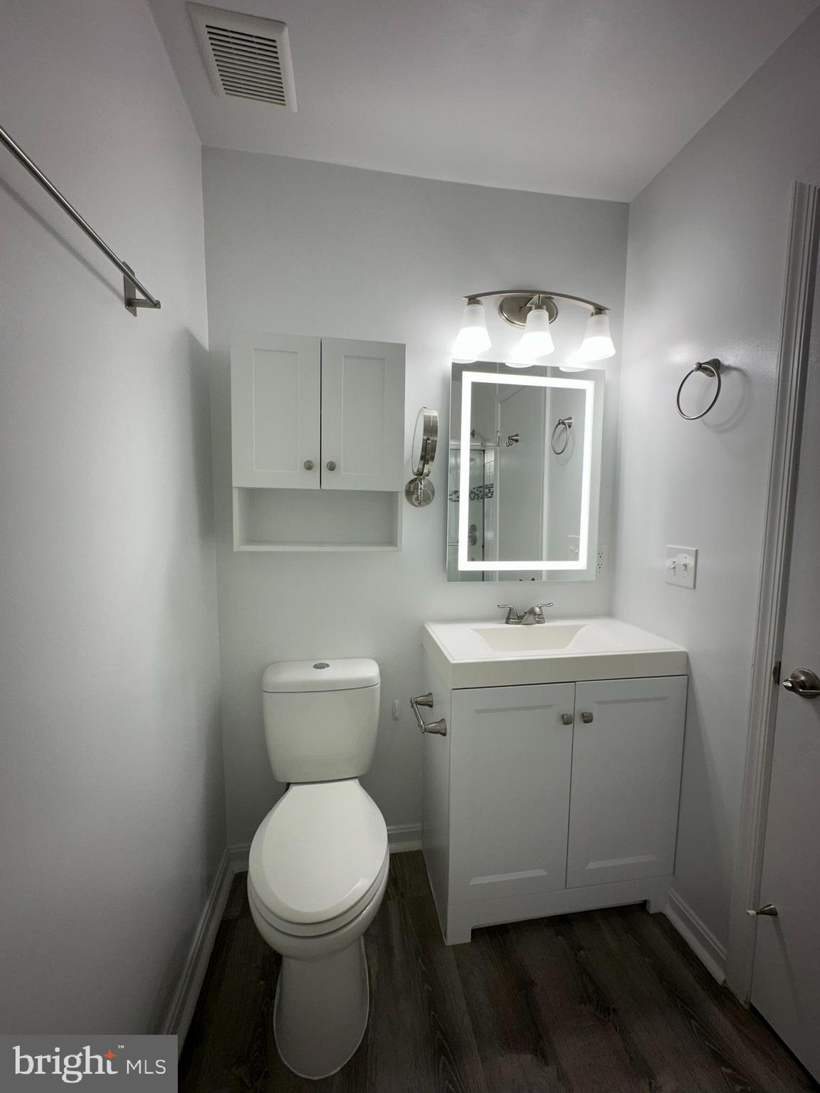 18334 Streamside Drive, Unit 202 Gaithersburg, MD 20879 - Photo 39 of 61 a bathroom with a toilet sink and mirror