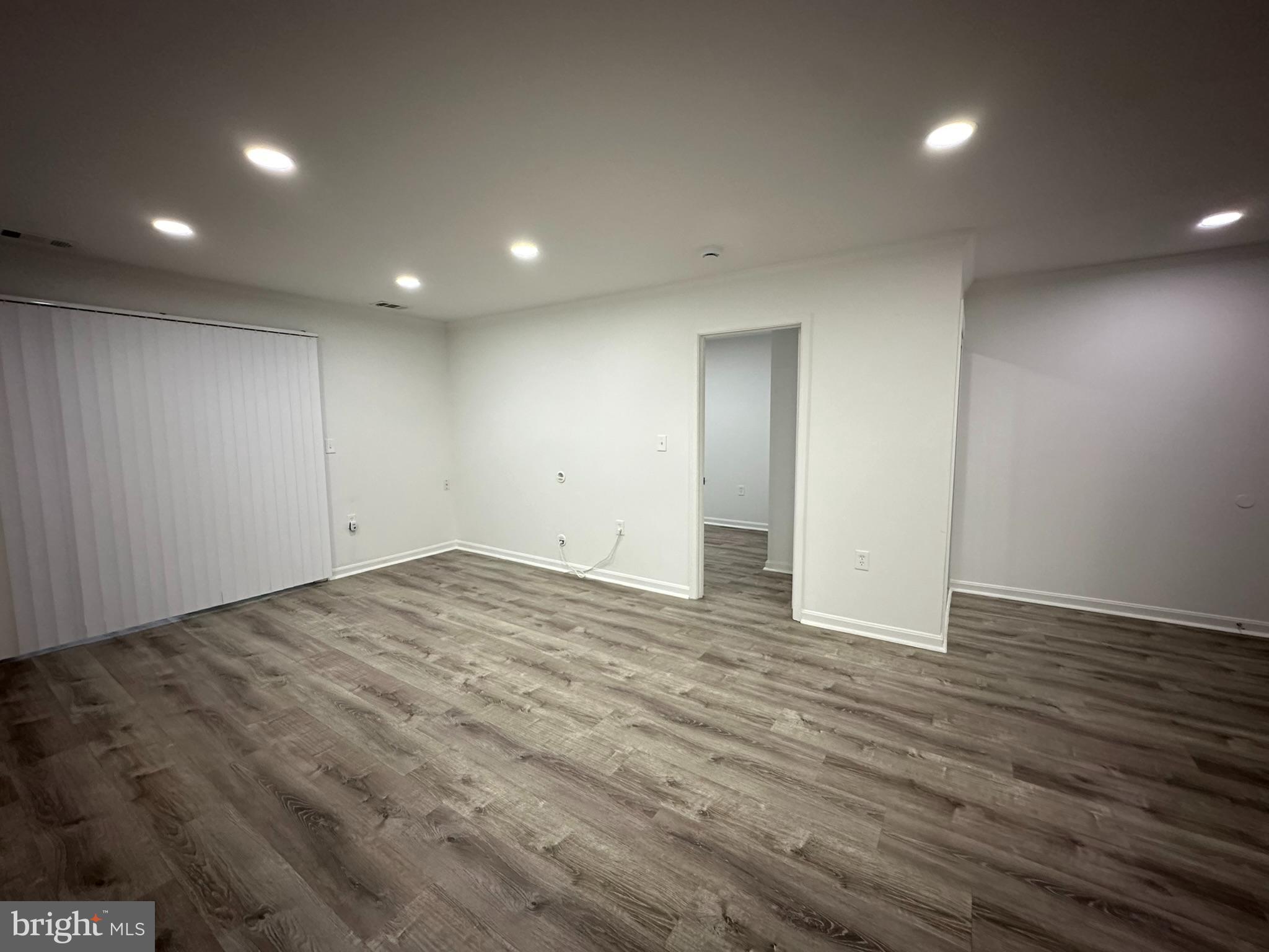 18334 Streamside Drive, Unit 202 Gaithersburg, MD 20879 - Photo 42 of 61 an empty room with wooden floor and windows