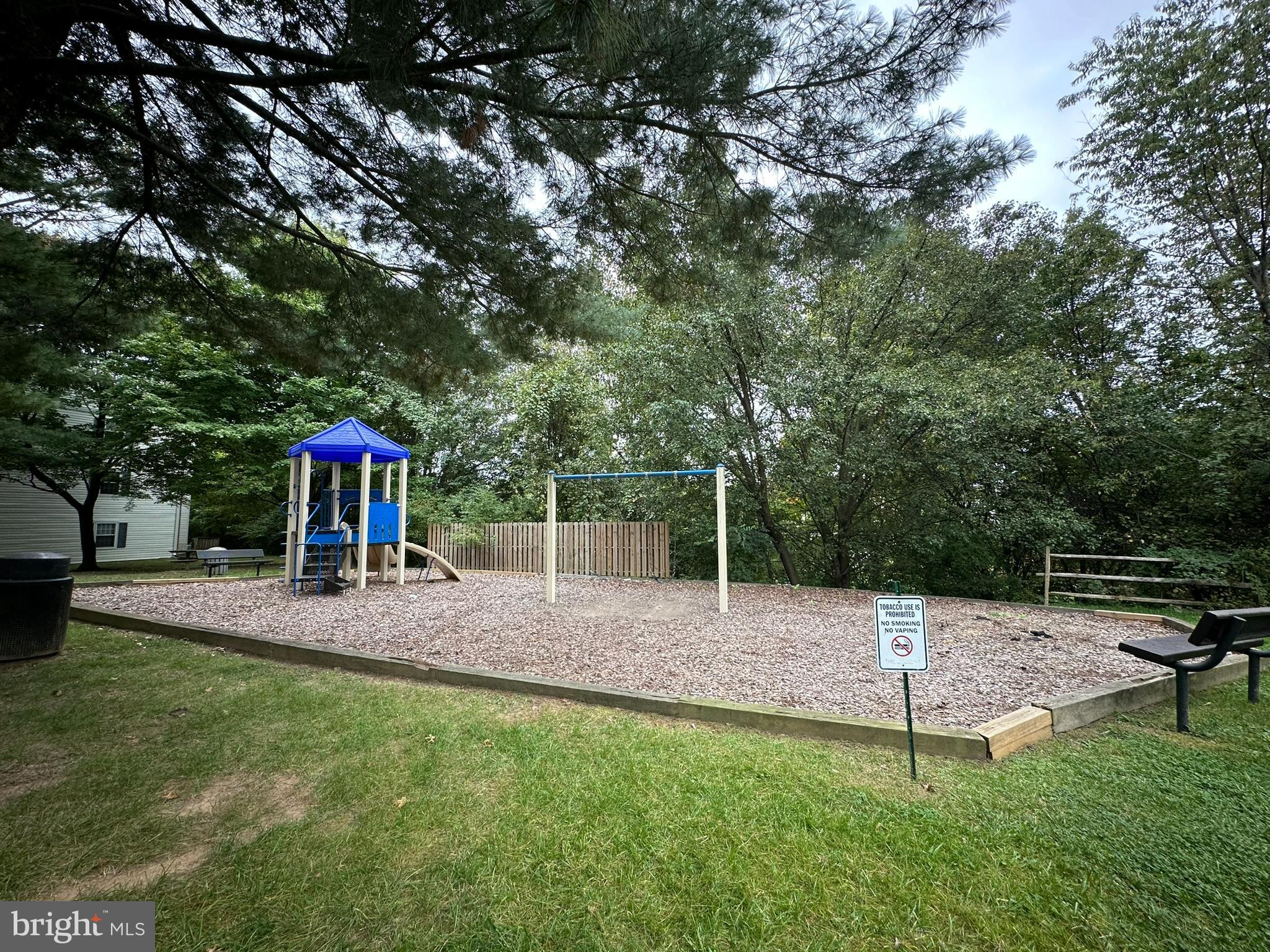 18334 Streamside Drive, Unit 202 Gaithersburg, MD 20879 - Photo 49 of 61 a backyard of a house with table and chairs