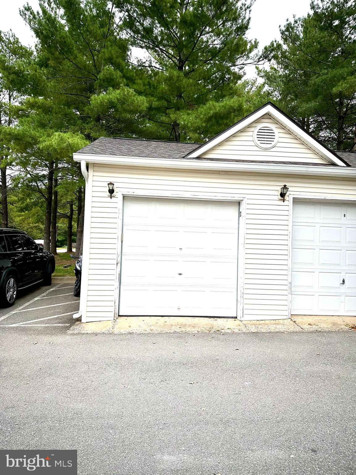 18334 Streamside Drive, Unit 202 Gaithersburg, MD 20879 - Photo 5 of 61 a view of a house with a garage
