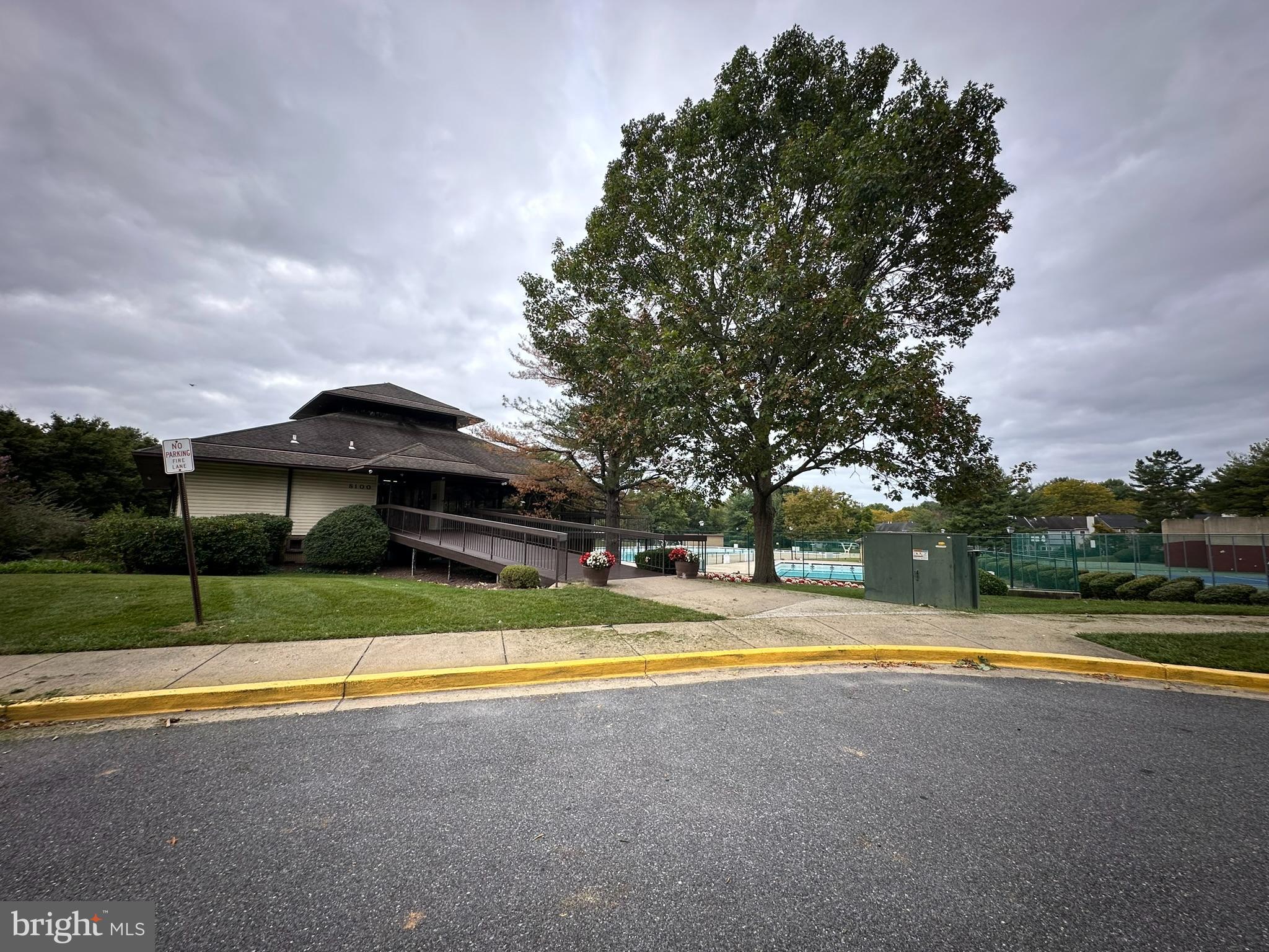 18334 Streamside Drive, Unit 202 Gaithersburg, MD 20879 - Photo 54 of 61 a view of swimming pool with lawn chairs and large trees