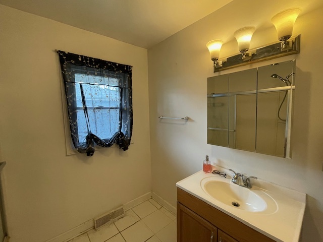 802 Westminster Road Joliet, IL 60435 - Photo 10 of 15 a bathroom with a sink and a mirror