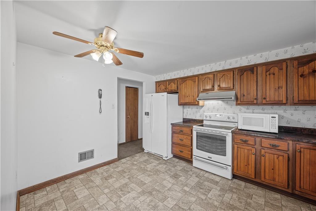 338-340 Golden Grove Road Baden, PA 15005 - Photo 5 of 25 a kitchen with stainless steel appliances a stove a refrigerator cabinets and a sink