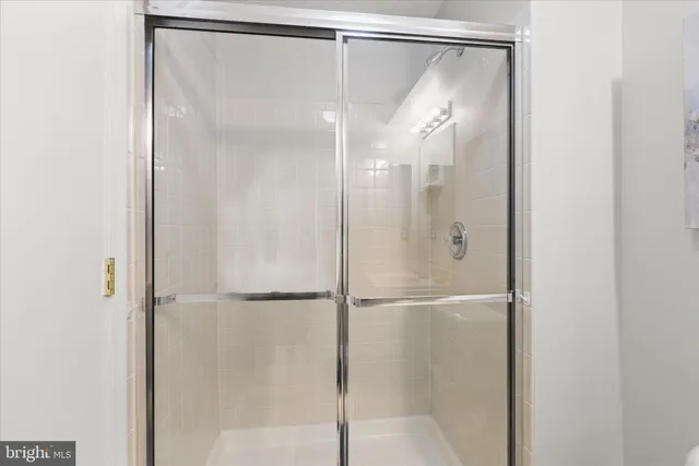a bathroom that has a glass shower door