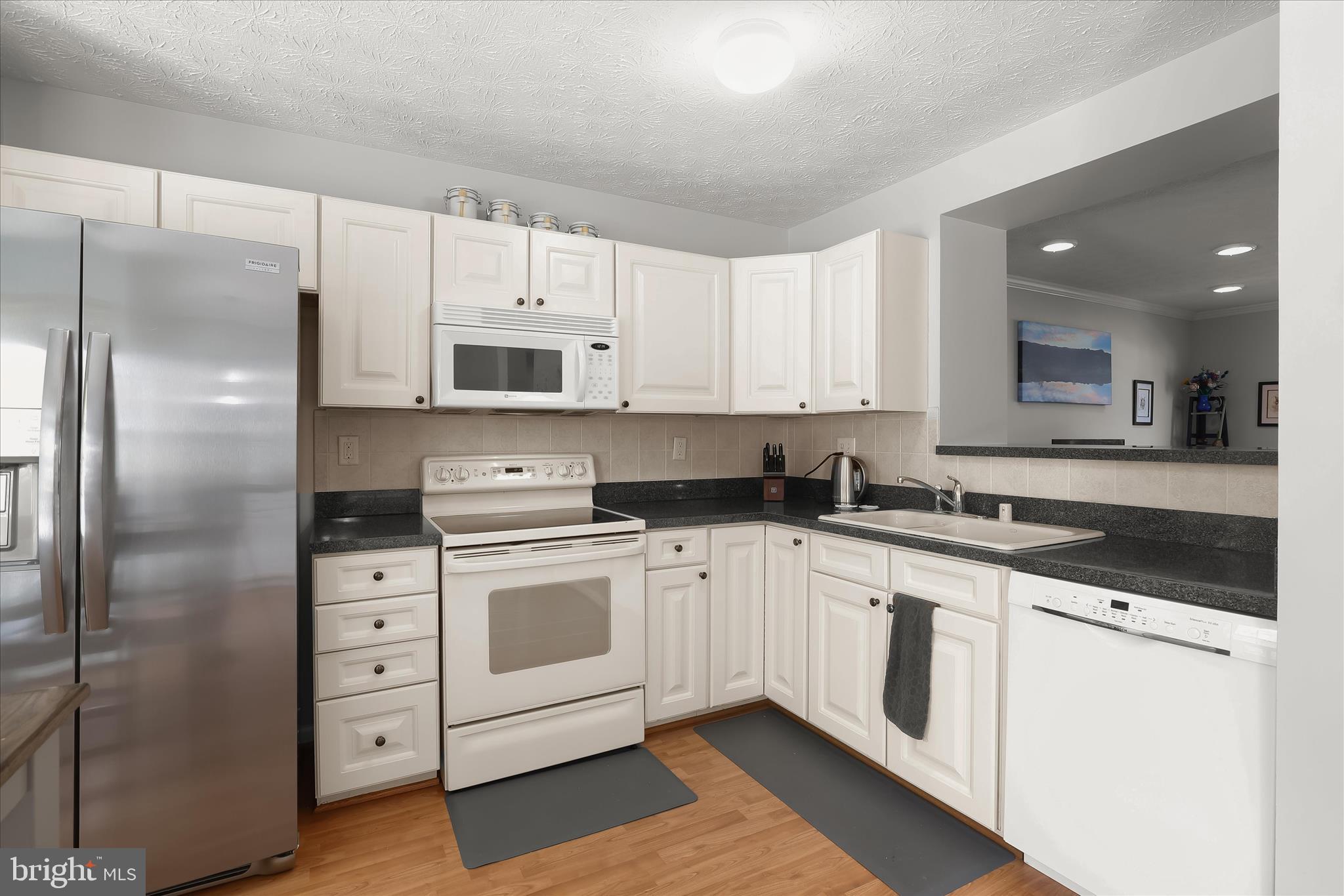 2019 Amber Way Baltimore, MD 21244 - Photo 8 of 27 a kitchen with white cabinets stainless steel appliances and a sink