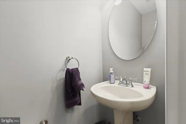 a bathroom with a sink a mirror and vanity
