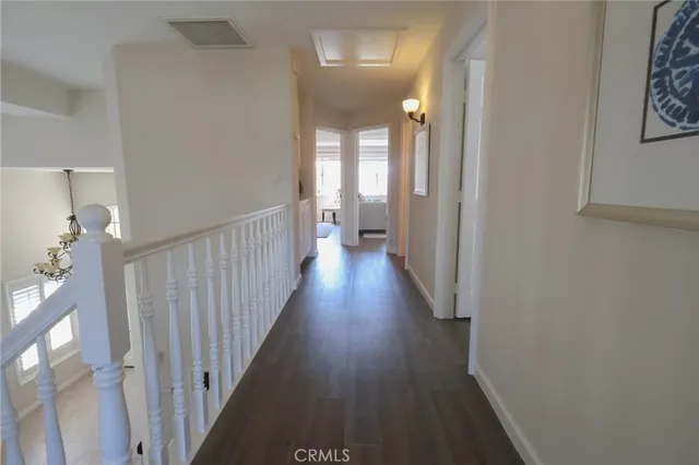 a view of a hallway with wooden floor
