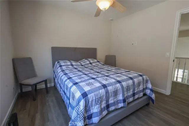 a large bed sitting in a bedroom next to a window and a chair