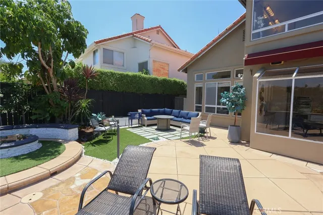 a view of a house with backyard sitting area and furniture
