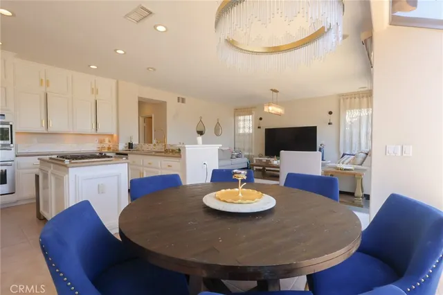 a kitchen with a dining table and chairs