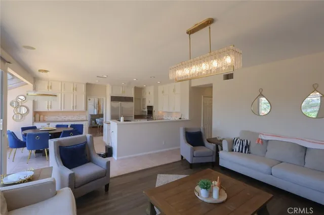 a living room with furniture and a chandelier