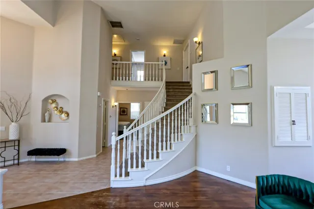 a view of entryway and hall with wooden floor