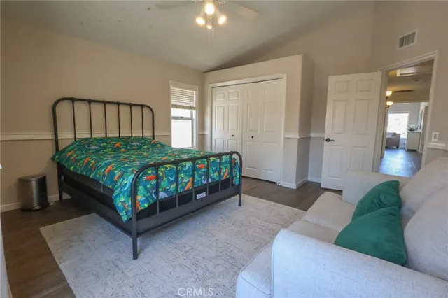 a bedroom with a bed a mirror and couch