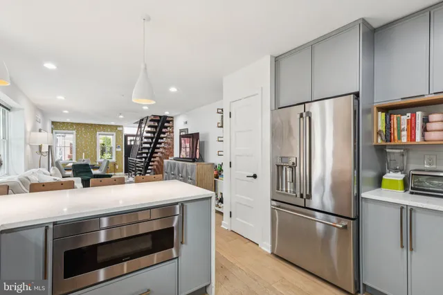 a kitchen with stainless steel appliances a refrigerator sink and cabinets