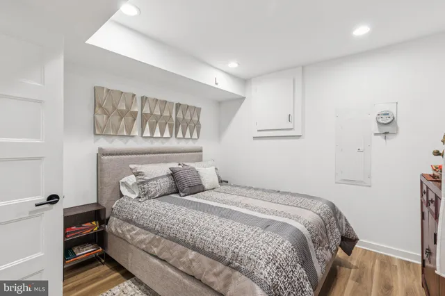 a bedroom with a bed and a night stand