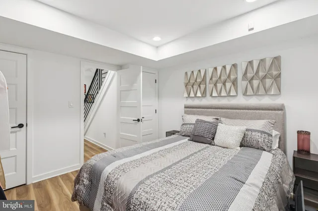 a bedroom with a large bed and a wooden floor