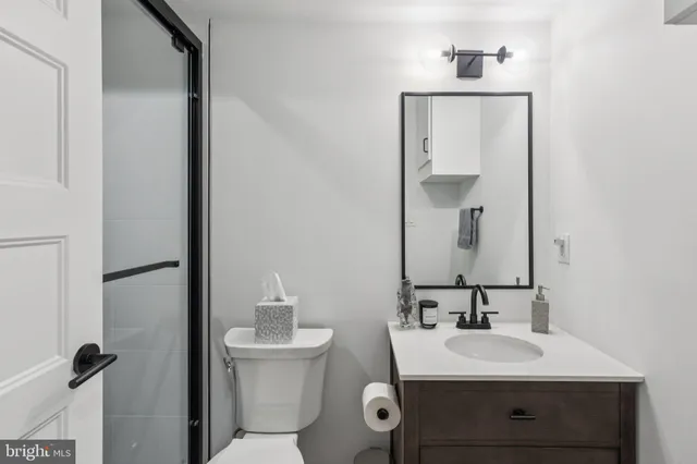 a bathroom with a toilet sink and mirror