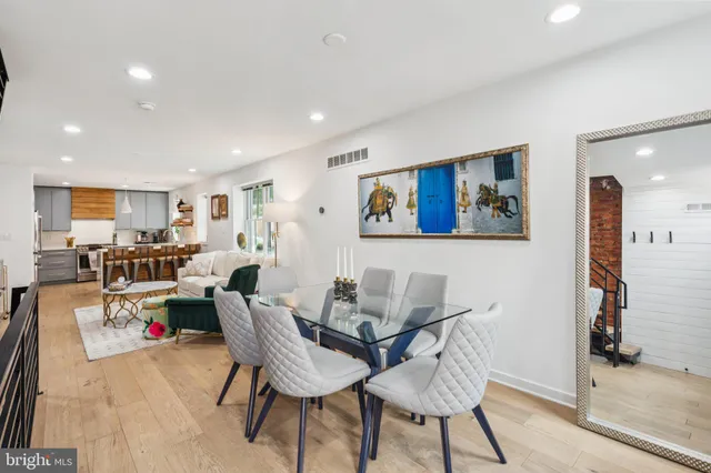 a living room with furniture and kitchen view