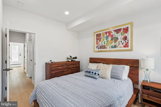 a bedroom with a bed and a painting on the wall