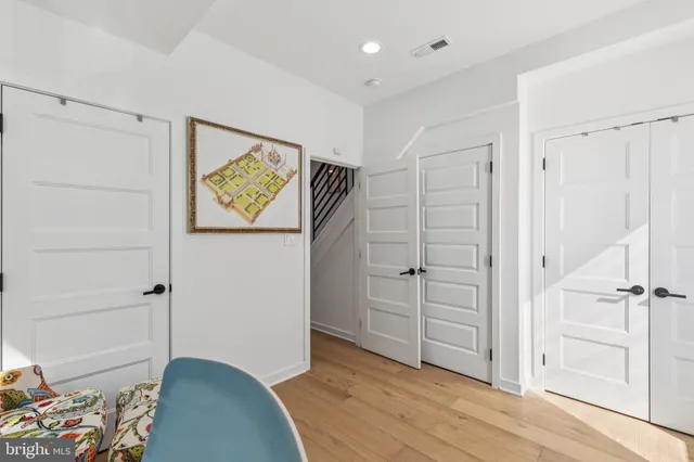 a view of a bedroom with wooden floor