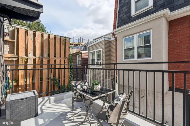 a view of a chair and table in the balcony