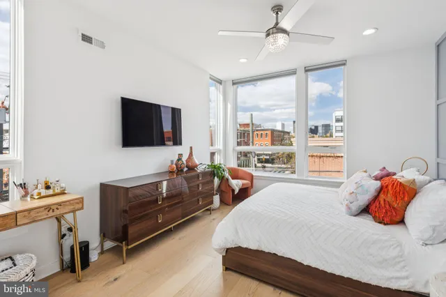 a bedroom with furniture and a flat screen tv