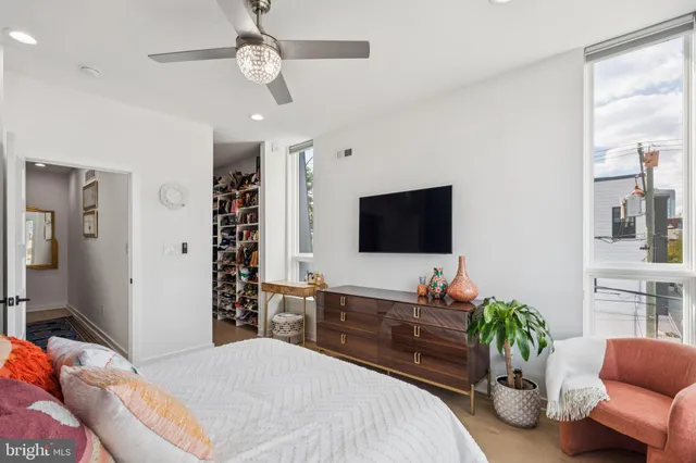 a bedroom with a bed and a flat screen tv