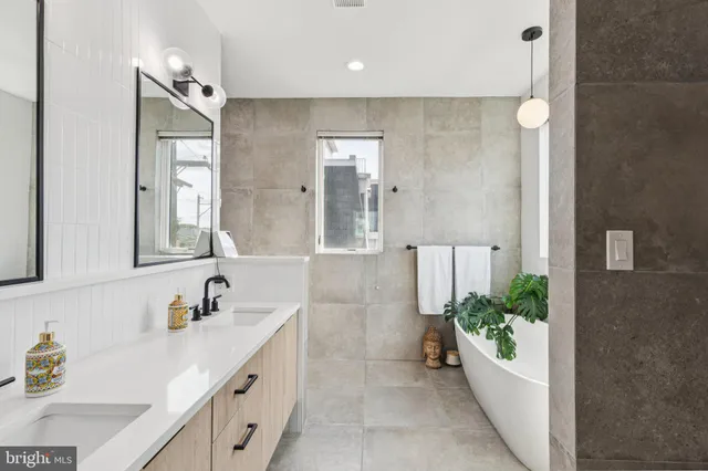 a spacious bathroom with a granite countertop sink and a mirror