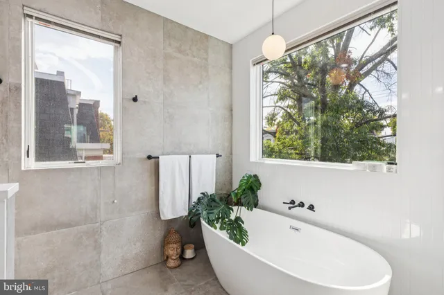a bath tub sitting in a bathroom next to a window