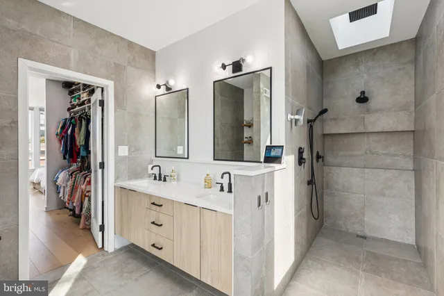a bathroom with a double vanity sink and mirror