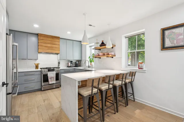 a kitchen with a table chairs stove and cabinets