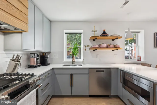 a kitchen with stainless steel appliances granite countertop a sink stove and window