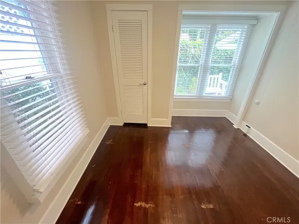 a view of a room with wooden floor and window