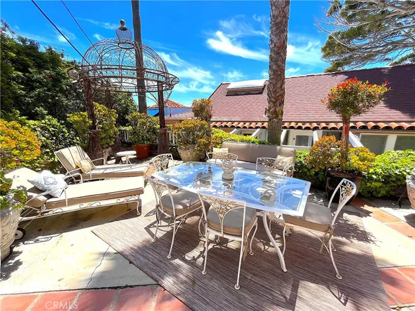 a view of a patio with table and chairs and potted plants