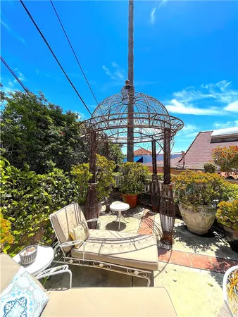a view of a backyard tables and chairs and potted plants