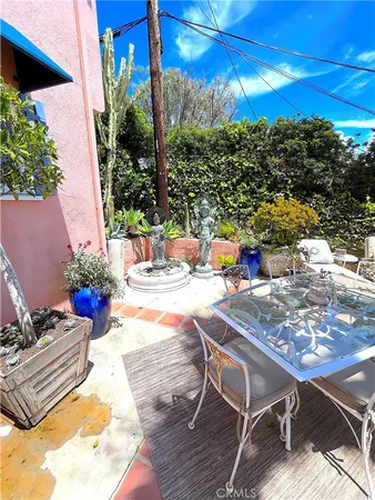 a view of a patio with couches and potted plants